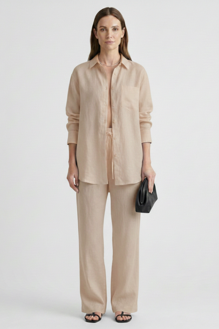 Fashionable women's two-piece set: button shirt & straight trousers. Versatile for work or elegant casual.