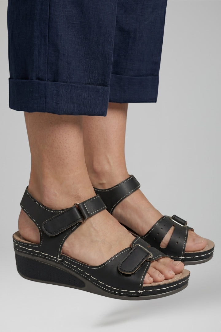Fashionable beige wedge sandals for women, designed with a comfortable cushioned footbed and stylish adjustable strap.