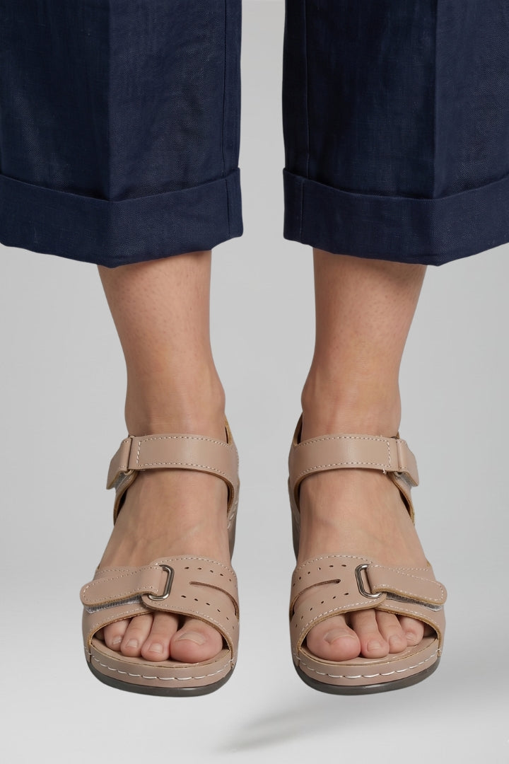 Chic beige women's wedge sandals with a soft cushioned insole & adjustable strap, combining fashion & all-day comfort.
