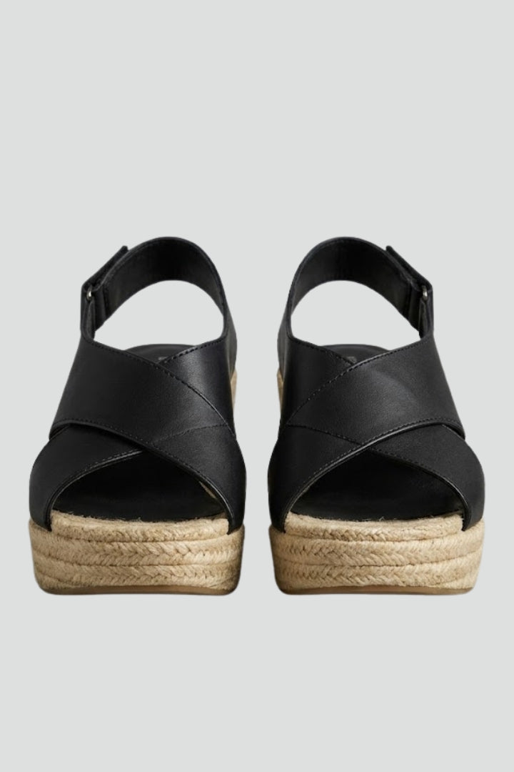 Women's wedge sandals with woven sole, ankle strap, and open toe for summer style.