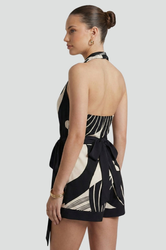 Women's black halter neck mini dress with a chic wrap style and tie waist. Versatile for parties & elegant wear.
