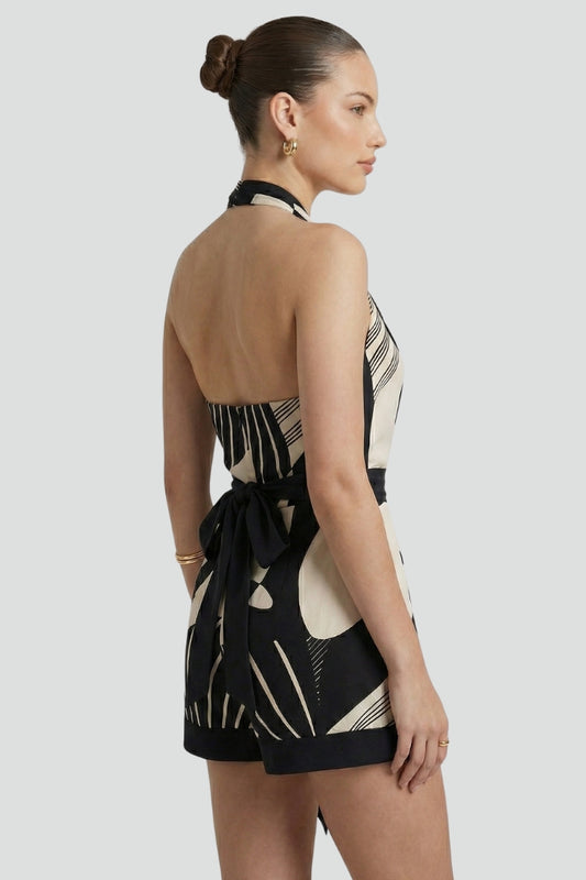 Women's black halter neck wrap mini dress with a stylish tie waist, perfect for a chic party look.