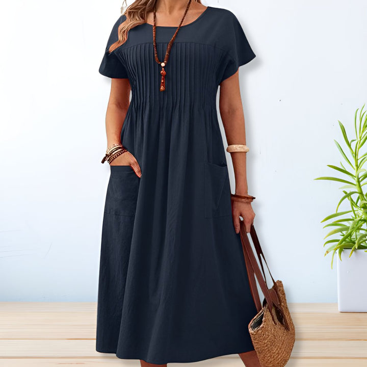 Stylish women's short sleeve midi day dress featuring a relaxed fit. Great for a comfortable, effortless casual summer look.