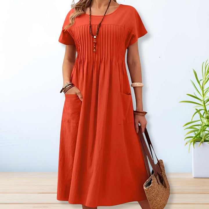 Women's relaxed fit midi day dress with short sleeves, perfect for casual everyday wear. Comfortable and stylish summer outfit.