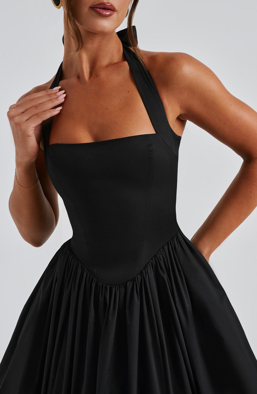 Side view of Ariana halter midi dress in black and white, women's wedding guest and event wear