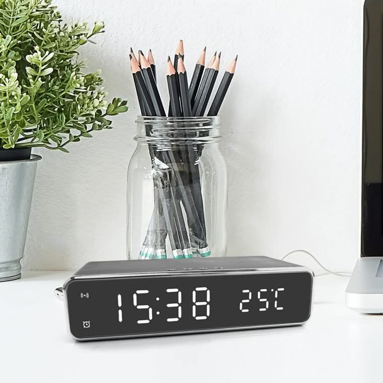 Modern LED alarm clock with fast wireless charging pad for bedside.