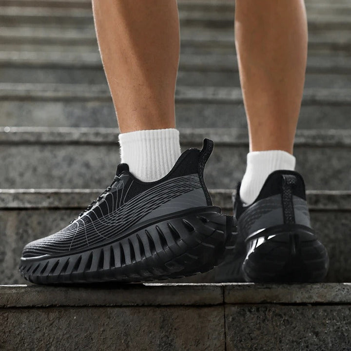 Side profile of black and green performance running shoe, showing sole & ankle support