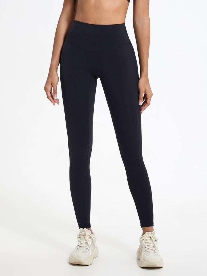 Close-up of the fabric on women's black high-waisted sculpting leggings, showcasing stretch and comfort