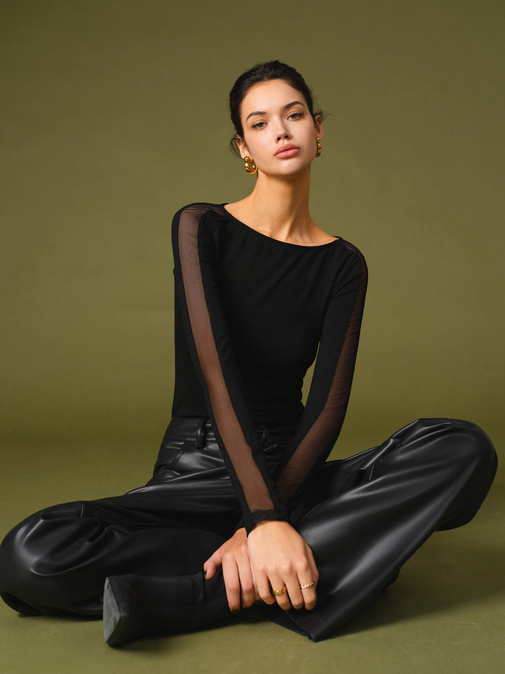 Black short-sleeve top for women, detailed with breathable mesh sleeves, spring fashion.