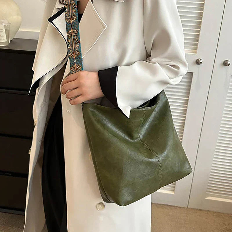 Boho women's shoulder bag with patterned strap, hobo style faux leather. Chic everyday accessory.