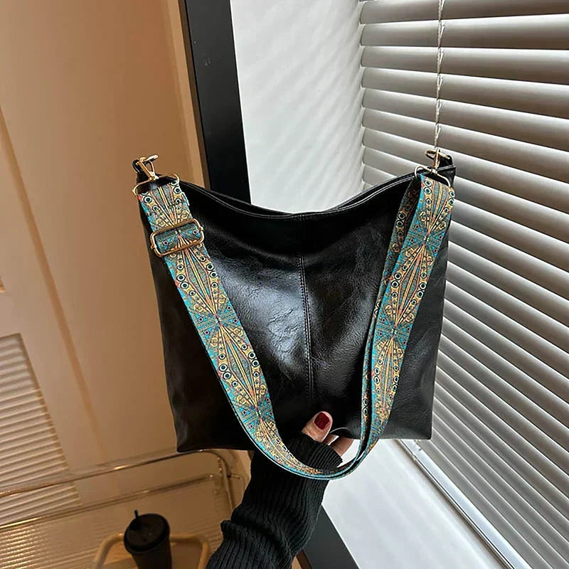 Versatile women's boho shoulder bag, hobo style, with a trendy patterned strap for chic everyday wear.