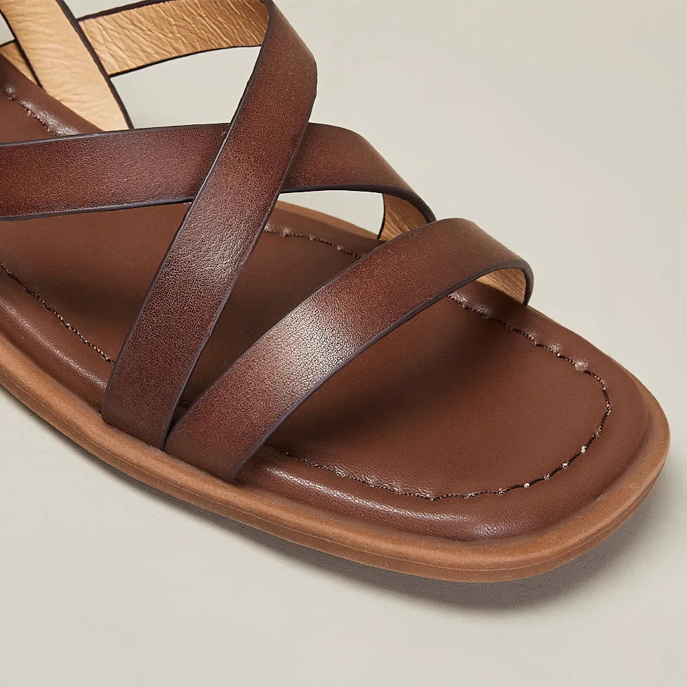 Close-up of the genuine leather texture on women's brown comfort sandals, showcasing quality