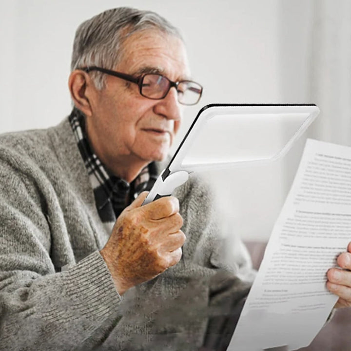 Full page magnifying glass with handle for comfortable reading. Ideal visual aid for low vision & hobbies.