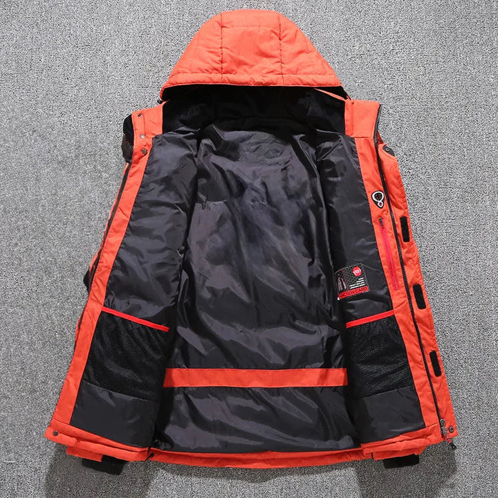 Man wearing a durable, insulated hooded parka jacket, ready for cold weather exploration.
