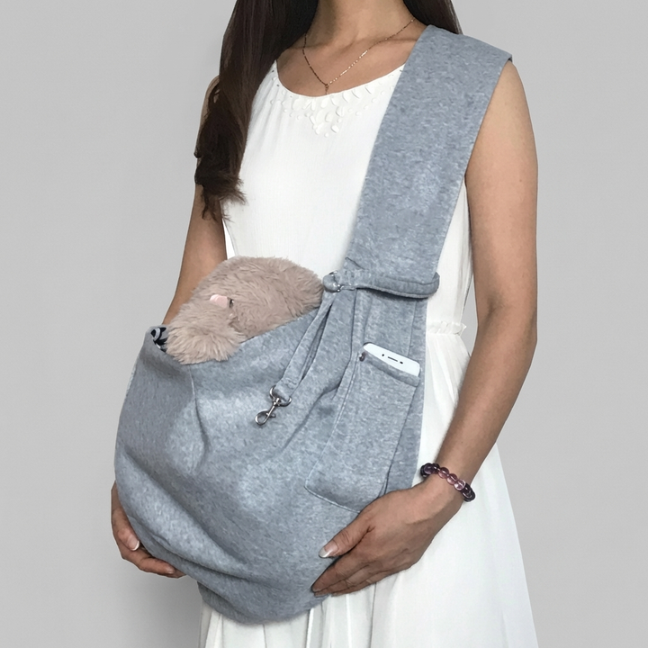 Comfortable small pet sling carrier, a hands-free travel bag for dogs & cats. Features adjustable strap & secure design.