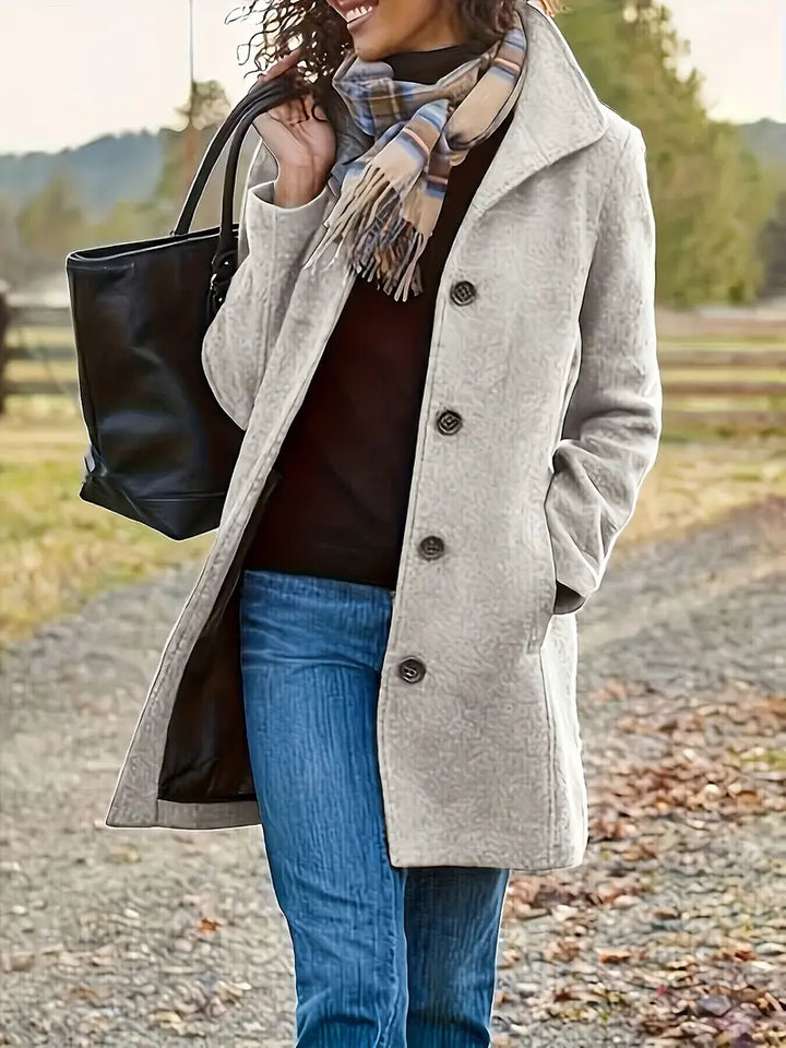 Women's classic mid-length trench coat with elegant lapel and button-front closure, perfect for fall and winter outerwear.