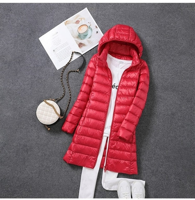 Stylish women's long hooded puffer coat, insulated for maximum warmth & versatile winter outerwear.