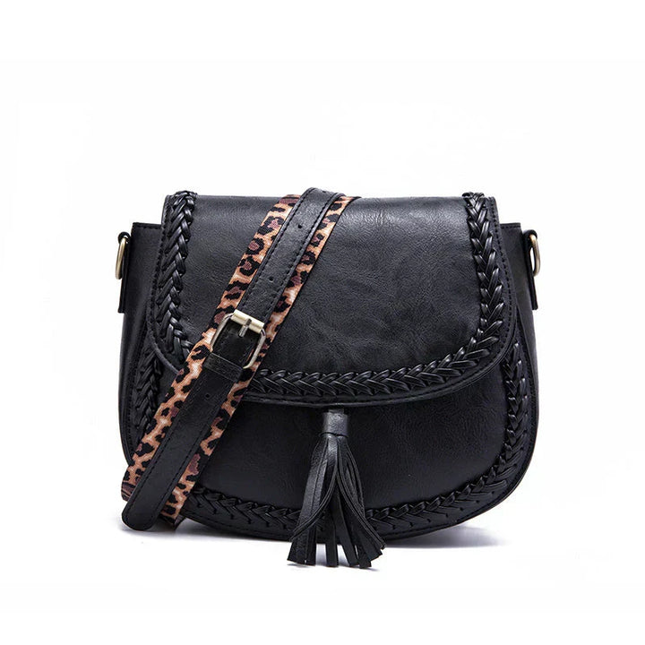 Versatile white women's elegant saddle bag with tassel. Chic crossbody shoulder handbag, perfect everyday accessory.