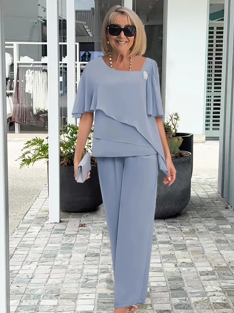 Chic women's asymmetrical top & wide-leg pant 2-piece set in elegant light blue. Perfect for evening or special occasions.