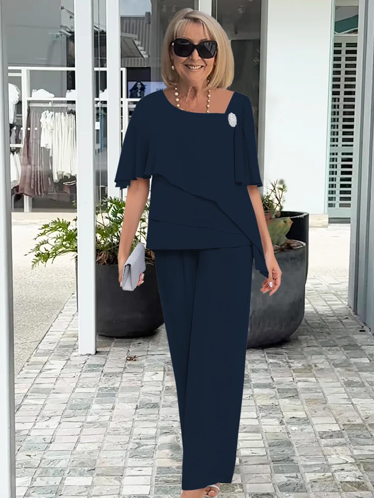 Elegant women's navy blue co-ord set with asymmetrical top and flowy wide-leg pants for formal wear and comfort.