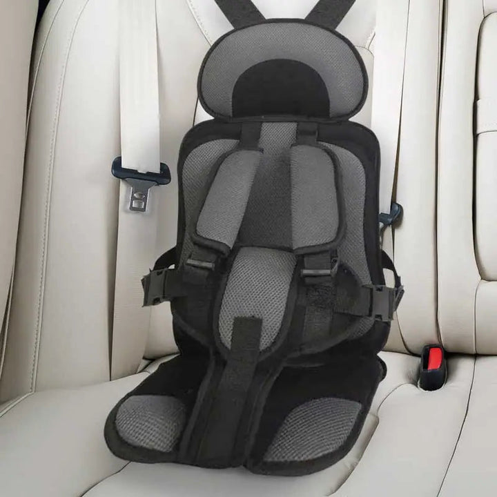 "Child safety car cushion seat in bright red with comfy padding and adjustable straps for secure, cozy travel."