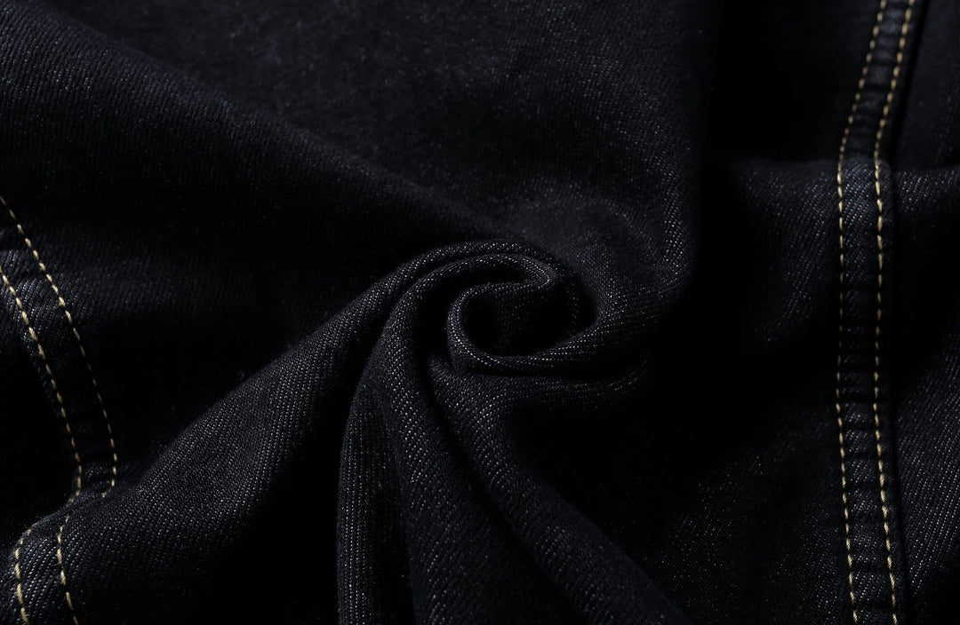 Close-up of the textured denim fabric on a unisex classic jacket, highlighting quality.