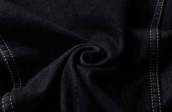 Close-up of the textured denim fabric on a unisex classic jacket, highlighting quality.