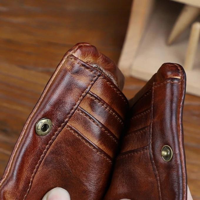 Close-up of the textured full-grain leather on a classic men's wallet in black.