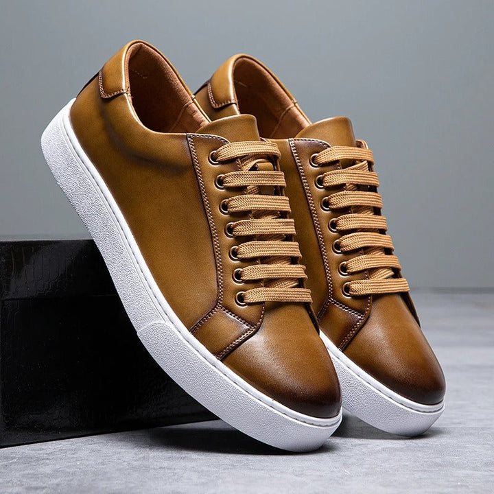 Men's classic navy blue leather low-top sneakers, ideal for dress casual outfits.
