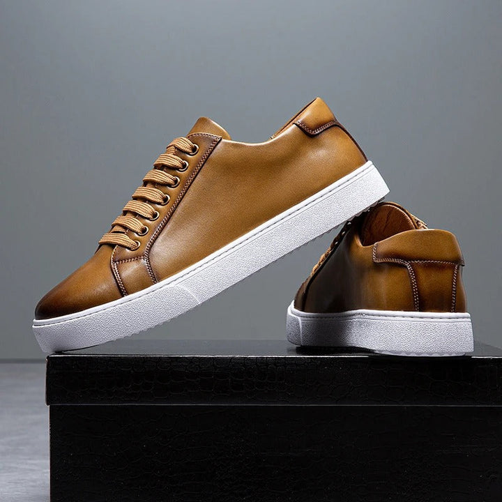 Close-up of the premium leather texture on men's low-top casual sneakers.