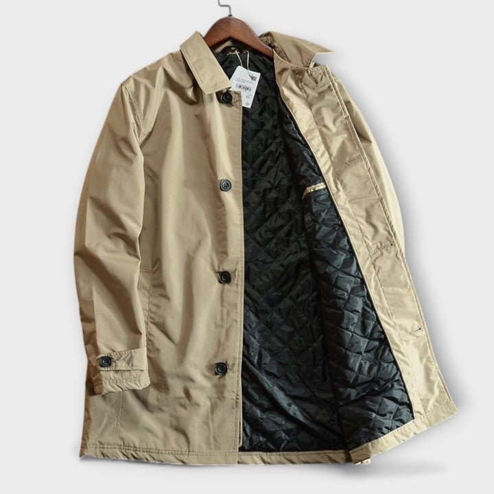 Button Front Men's Coat: Detail shot of a men's classic car coat, highlighting the elegant button-front closure & clean lines.