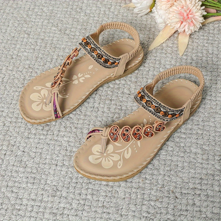 Side view of women's flat boho sandals, showcasing rhinestone and beaded embellishments.