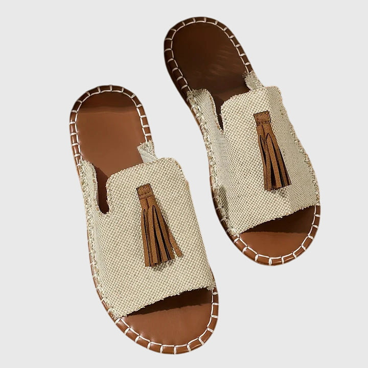 Versatile women's comfortable sandals with flat sole, open toe, and chic tassel strap design.