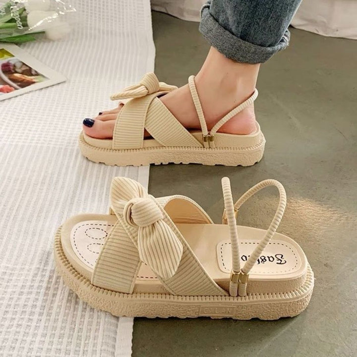 Trendy women's slip-on sandals with adjustable straps & open toe, perfect for summer beach days.