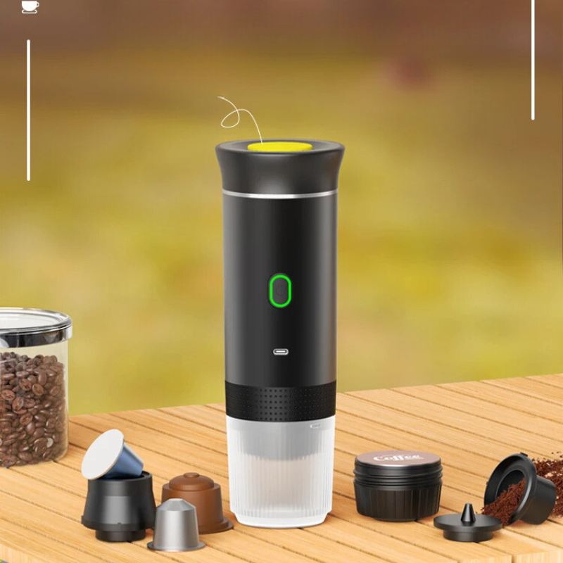 "Compact portable espresso maker, USB charged, black sleek design, suitable for ground coffee and capsules."