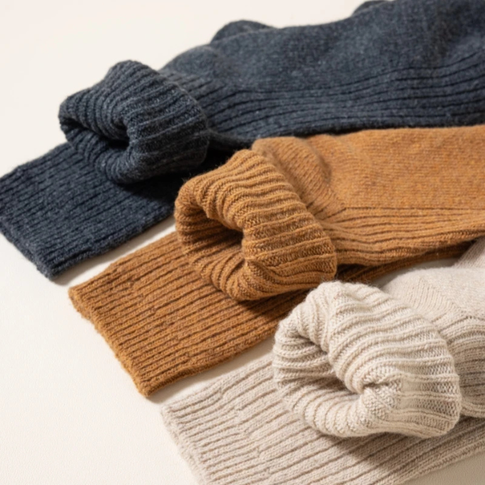 Single cozy wool winter sock, highlighting its thick knit and unisex warm appeal.