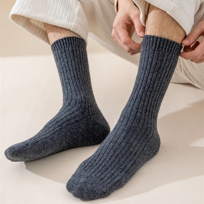 Close-up of the textured knit on a cozy wool winter sock, highlighting its warmth and quality.