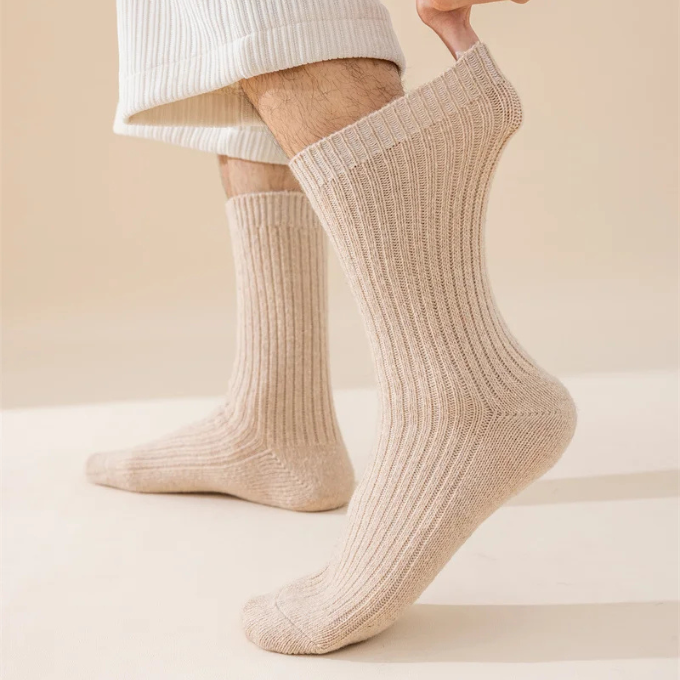 Folded cozy knit wool winter socks, showcasing their thick, warm material for unisex wear.
