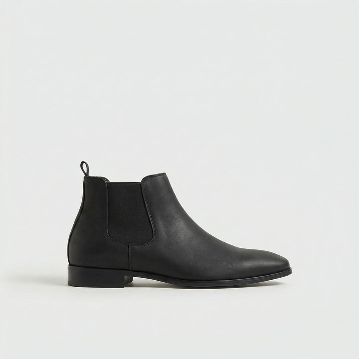 Men's black versatile Chelsea boots. Stylish slip-on footwear for everyday casual or dress wear.
