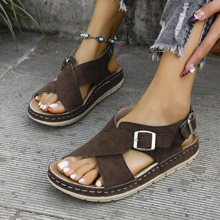Stylish gray platform cross-strap sandals for women, featuring soft cushioning.