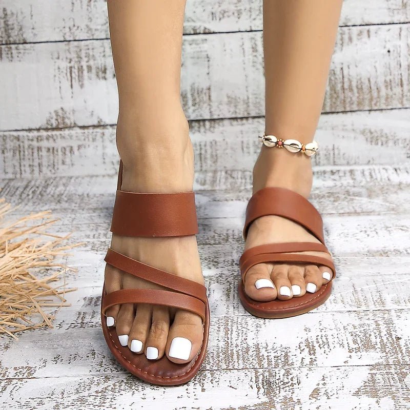 Versatile women's cross-strap flat sandals, ideal for summer, beach, or daily wear.