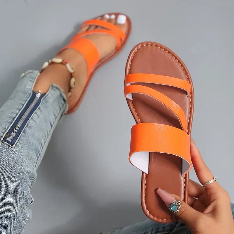 Comfortable women's cushioned flat sandals with chic cross-straps, perfect for summer.