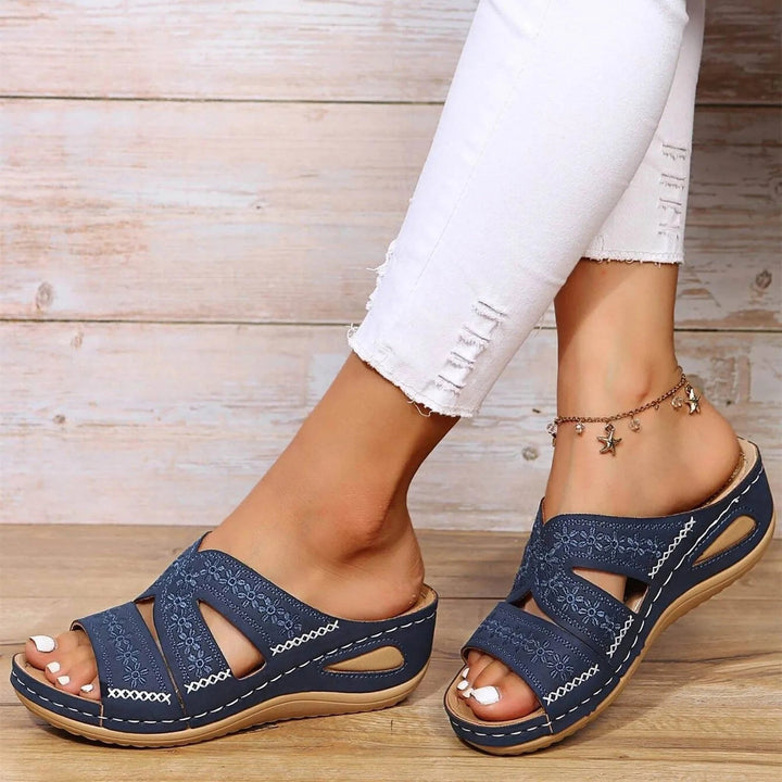 Adjustable cross-strap orthopedic sandals for women, offering custom comfort & foot support.
