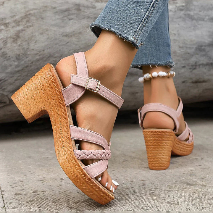 Bohemian women's cross-strap sandals with an open toe, adjustable straps, and a chic woven sole.