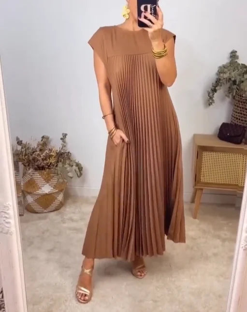 Close-up of a stylish women's pleated maxi dress, showcasing its flowing, elegant pleats & versatile design.