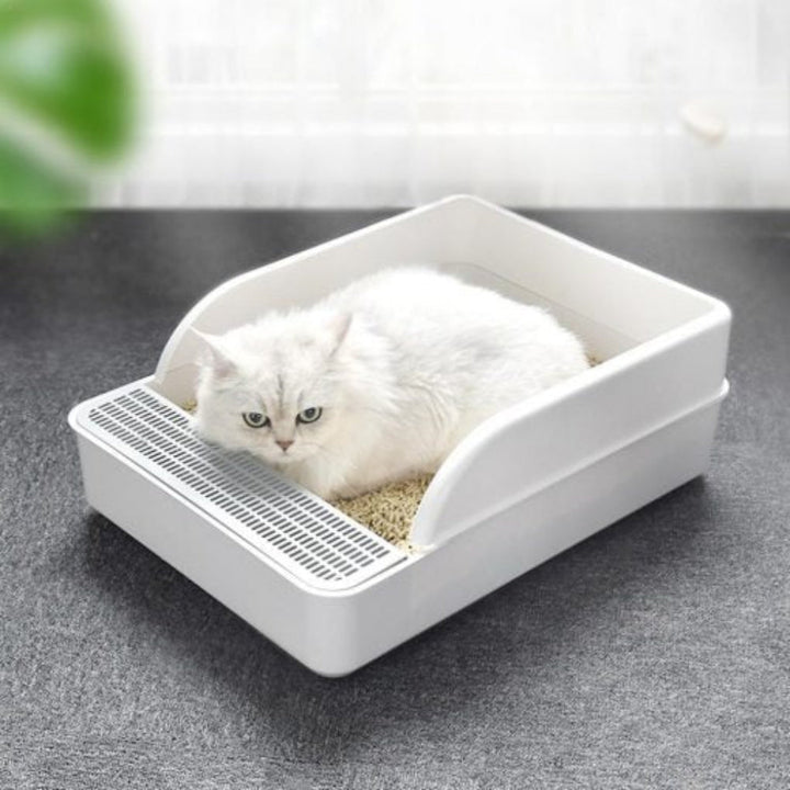No-mess, high-sided cat litter box. Easy-clean tray for pet hygiene. Essential cat accessory for odor control.