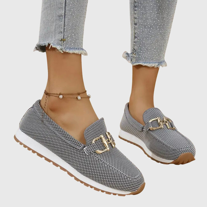 Women's dusty blue slip-on loafers featuring a stylish horsebit. Comfortable and preppy footwear for casual outfits.