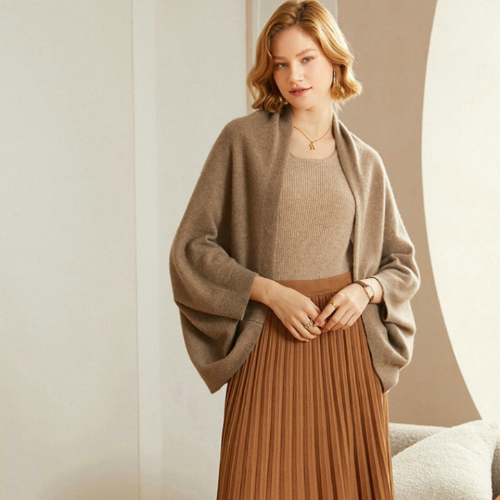 Versatile black knit shawl wrap, styled casually over a sweater.