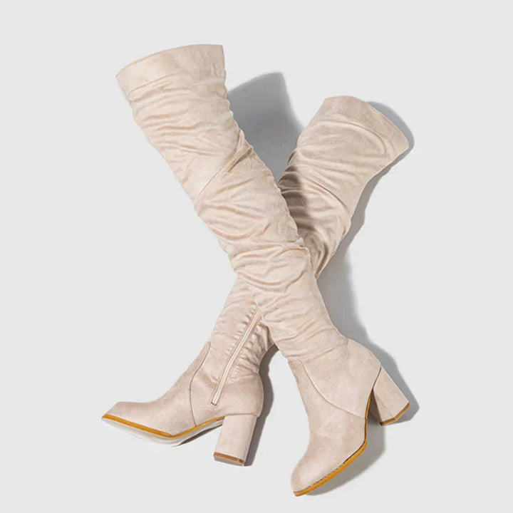 Full view of women's over-the-knee heeled boots, highlighting their long, slimming silhouette.