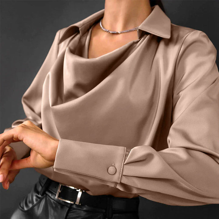 Close-up of a women's bronze satin blouse featuring a sophisticated drape neck and long sleeves, silky feel.